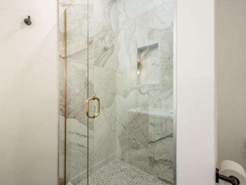 a shower with a glass door in a bathroom at Modern Luxury 4BR 3 5BA Oasis in Historic Old Town East PD in Columbus