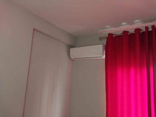 a room with a red curtain and a heater at Home sweet Home 2 - Guest House in Tirana