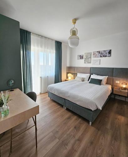 a bedroom with a large bed and a table at B&B Domus Teano Luxury Rooms in Rome