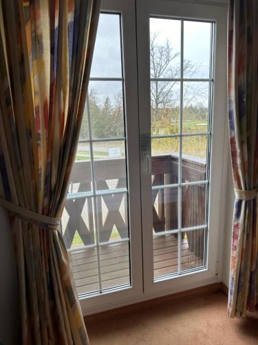 a room with a window with a view of a deck at Hotel am Spreebogen in Burg