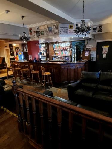 a bar in a pub with a couch and chairs at Xtasia Adult Hotel - Adults Only in West Bromwich