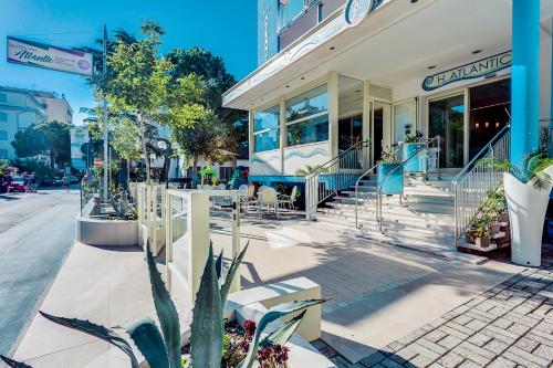 a building on a street with a cactus in front of it at Hotel Atlantic in Gatteo a Mare