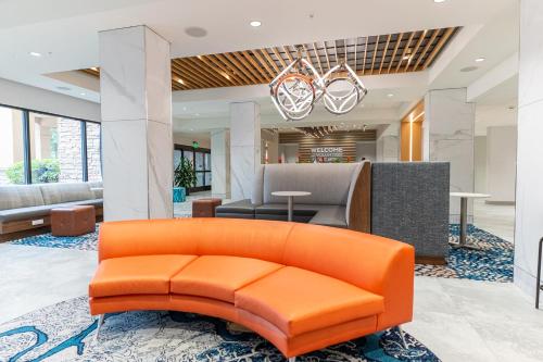 an orange couch in an office lobby with a reception at Hampton Inn Knoxville-West At Cedar Bluff in Knoxville