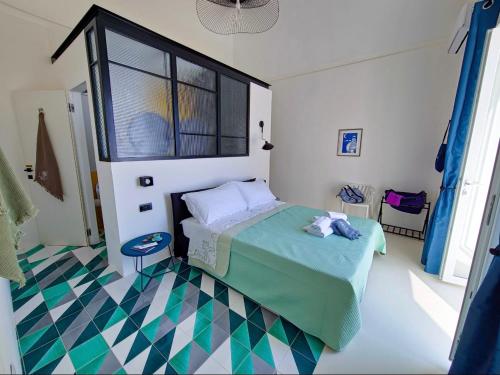 a bedroom with a bed and a checkered floor at La Pigolina Blue in Positano