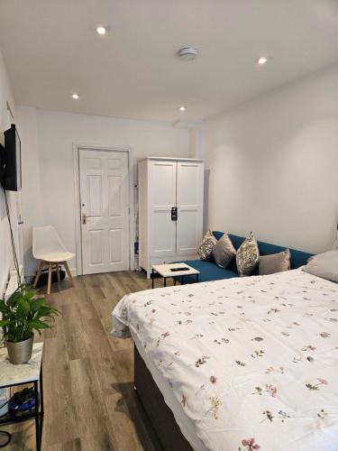 a bedroom with a large bed and a couch at Brand New Private Annex Guest Suite in Chandlers Ford