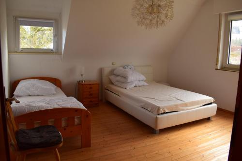 a bedroom with two beds with towels on them at Hunsrück in Schauren