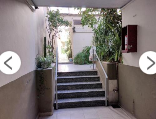 a hallway with stairs with plants in a building at Camino de tango tu lugar soñado in Buenos Aires