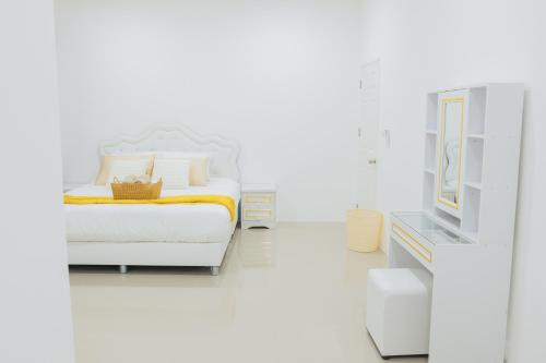 a white bedroom with a bed and a tv at Private 3BR Pool House Near Pattaya Beach in Ban Huai Yai