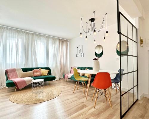 a living room with a couch and a table and chairs at Apartamentos 2K - Apartamento de diseño en centro de Castro Urdiales in Castro-Urdiales