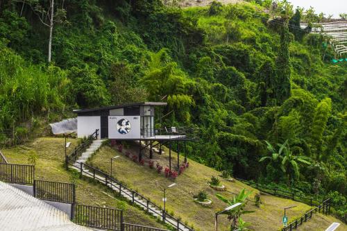 a small building on the side of a hill at Zoi Eco Hotel in Manizales