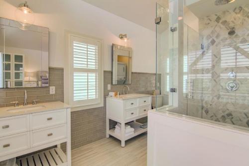 a bathroom with a shower and a sink and a tub at Pure Joy by AvantStay Beach Home w Amazing Views Community Pool in Isle of Palms