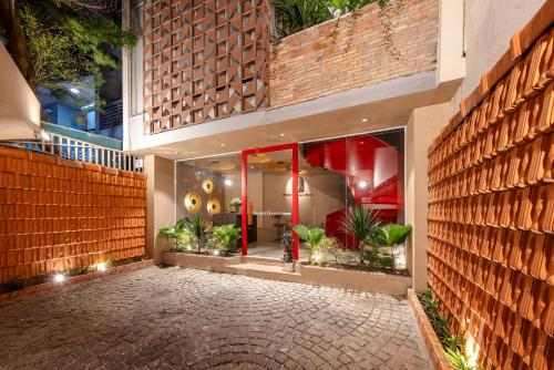 a store front with a brick wall and plants at Secret Garden Hotel in Ho Chi Minh City