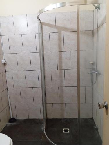 a shower with a glass door in a bathroom at CG ALQUILERES in Tacuarembó