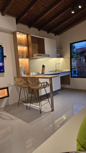 a kitchen with a table and two chairs and a tv at 'SELECT' Medellin in Medellín