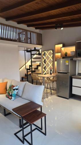 a living room with a couch and a table and a kitchen at 'SELECT' Medellin in Medellín