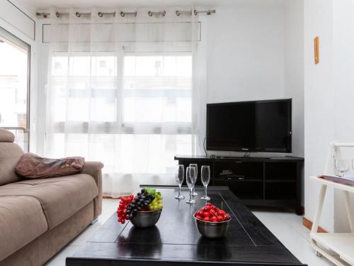 a living room with a coffee table with wine glasses at Apartment Emporda-1 by Interhome in Llança