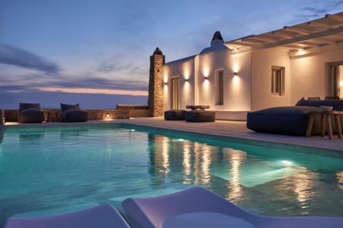 a villa with a swimming pool at night at Annez Villa with Private Pool Panoramic Sea View in Mikonos