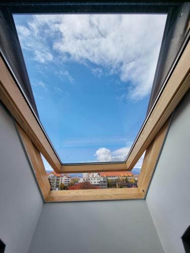 a window in a room with a blue sky at Pensiunea Korona in Miercurea-Ciuc