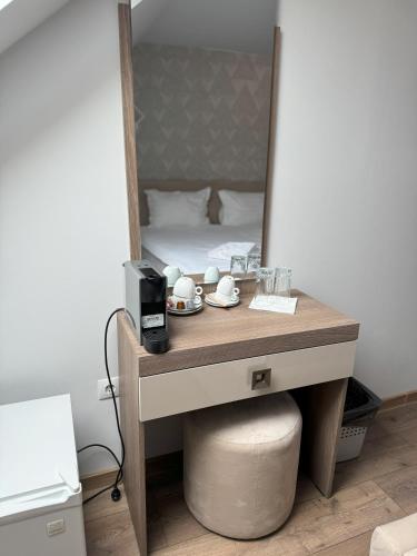 a dressing table with a mirror and a bed at Pensiunea Korona in Miercurea-Ciuc