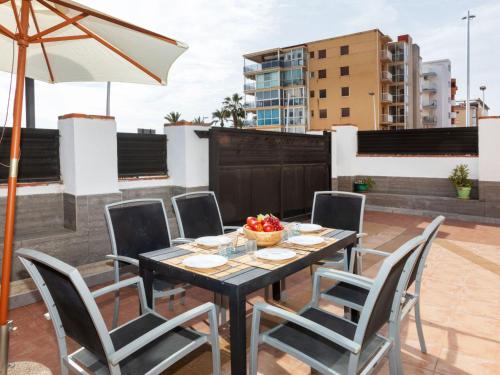 un patio con mesa y sillas en la azotea en Holiday Home Del Sol by Interhome en Salou