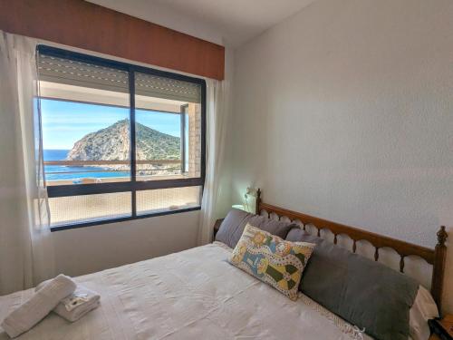 a bedroom with a bed and a large window at Apartment Cala Blanca by Interhome in Cala de Finestrat