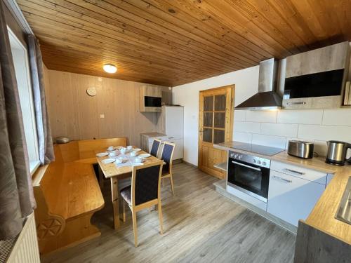 a kitchen with a table and a stove top oven at Holiday Home Martin by Interhome in Wald