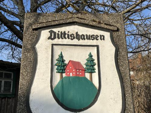 a sign with a picture of a house and trees at Holiday Home Romeo by Interhome in Dittishausen