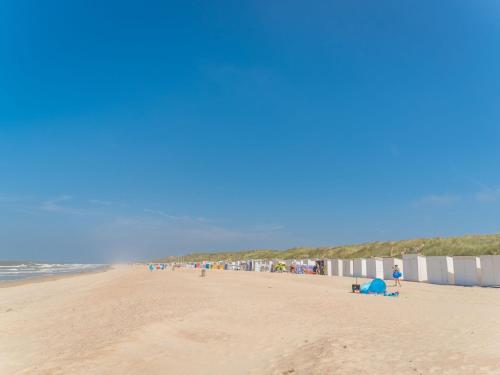 a group of people on a beach near the ocean at Apartment Appartement 64-202 by Interhome in Bredene