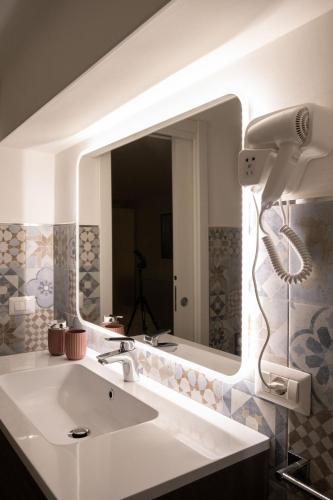 a bathroom with a sink and a large mirror at URBAN HOME in Bari