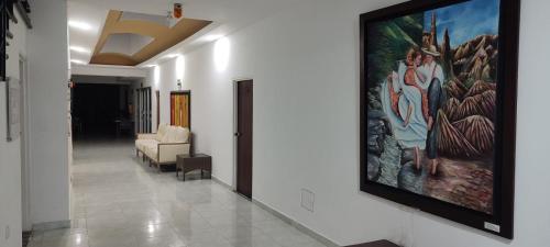 a hallway with a large painting on the wall at Hotel Panama in Neiva