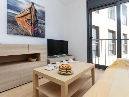 Televízia a/alebo spoločenská miestnosť v ubytovaní Apartment Escorxador by Interhome