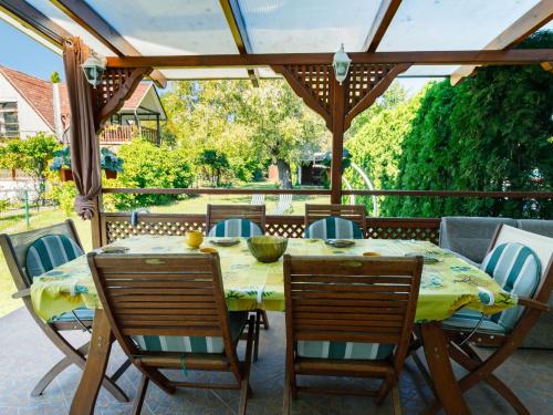 a dining table and chairs on a patio at Holiday Home Aurora by Interhome in Zamárdi