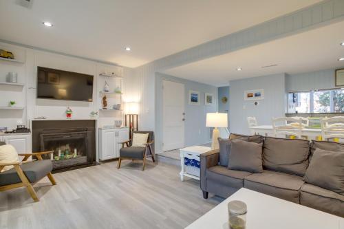 a living room with a couch and a fireplace at 1 Mi to Bethany Beach Townhome with Screened Porch! in Bethany Beach