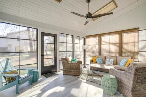 a living room with a couch and chairs and a ceiling fan at 1 Mi to Bethany Beach Townhome with Screened Porch! in Bethany Beach