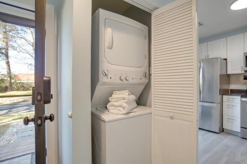 a kitchen with a washer and dryer with towels at 1 Mi to Bethany Beach Townhome with Screened Porch! in Bethany Beach