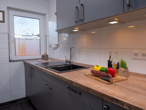 una cucina con bancone, lavandino e tagliere di Holiday Home Kotthaus by Interhome a Norddeich