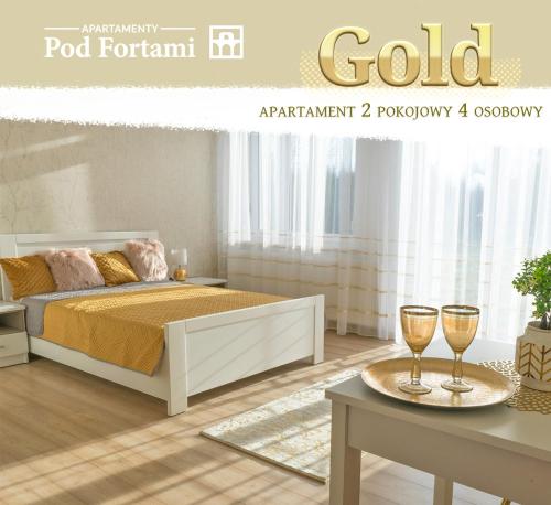 Apartamenty Pod Fortami في برزيميسل: غرفة نوم بسرير وكأسين على طاولة