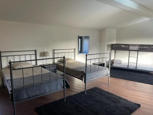 a room with two bunk beds and a rug at Casa do Caseiro in Outeiro Maior