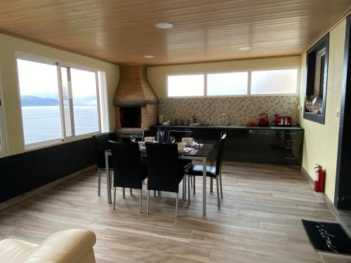 a kitchen and dining room with a table and chairs at The Vista House in Ponta Delgada