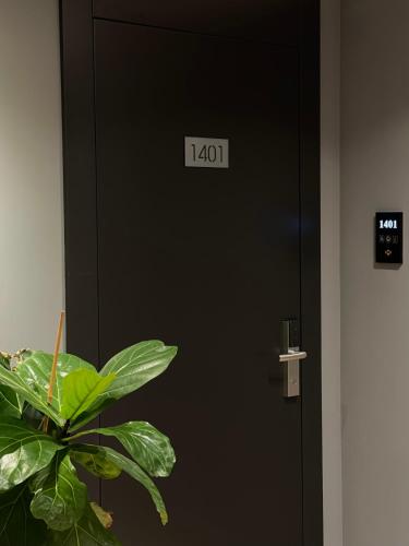 a black door with a clock on it at Mulaj Hotel in Tirana
