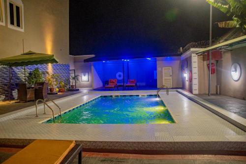 a swimming pool in a hotel at night at Crownsville Hotel - Airport Road in Port Harcourt