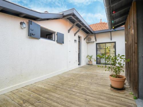 une cour d'une maison avec une terrasse en bois dans l'établissement Holiday Home Villa Albertine by Interhome, à Arcachon