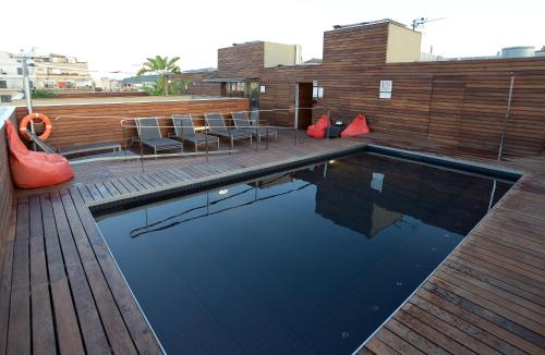 a swimming pool on top of a building at Hotel Soho in Barcelona