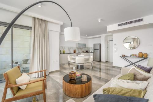 a living room with a couch and a table at Unique Masterpiece in the Heart of Jerusalem in Jerusalem