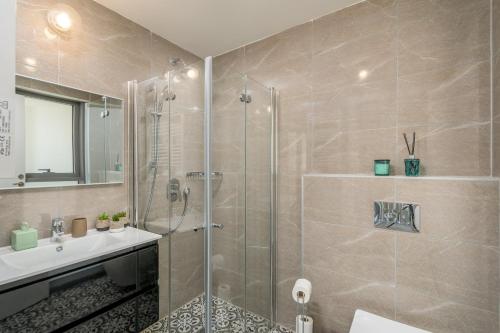 a bathroom with a shower and a sink at Unique Masterpiece in the Heart of Jerusalem in Jerusalem