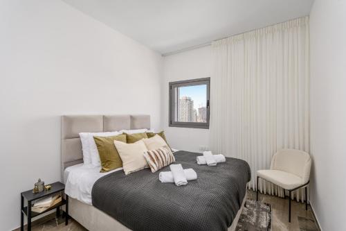 a bedroom with a bed with two towels on it at Unique Masterpiece in the Heart of Jerusalem in Jerusalem