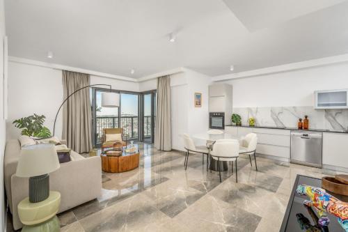 a kitchen and living room with a table and chairs at Unique Masterpiece in the Heart of Jerusalem in Jerusalem