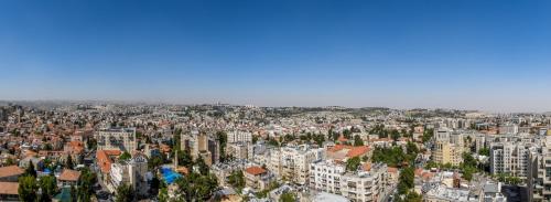 an aerial view of a city with tall buildings at Unique Masterpiece in the Heart of Jerusalem in Jerusalem