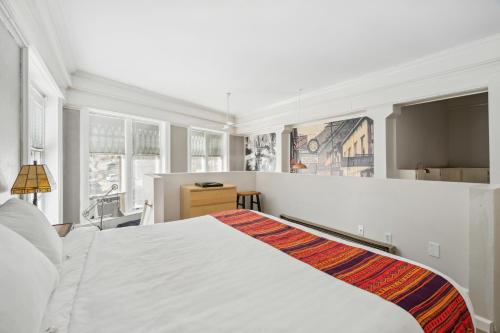 a bedroom with a white bed and a window at THE CARRICK in Bisbee