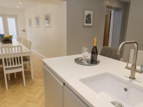 a kitchen with a sink and a bottle of wine at Station House in Scarborough